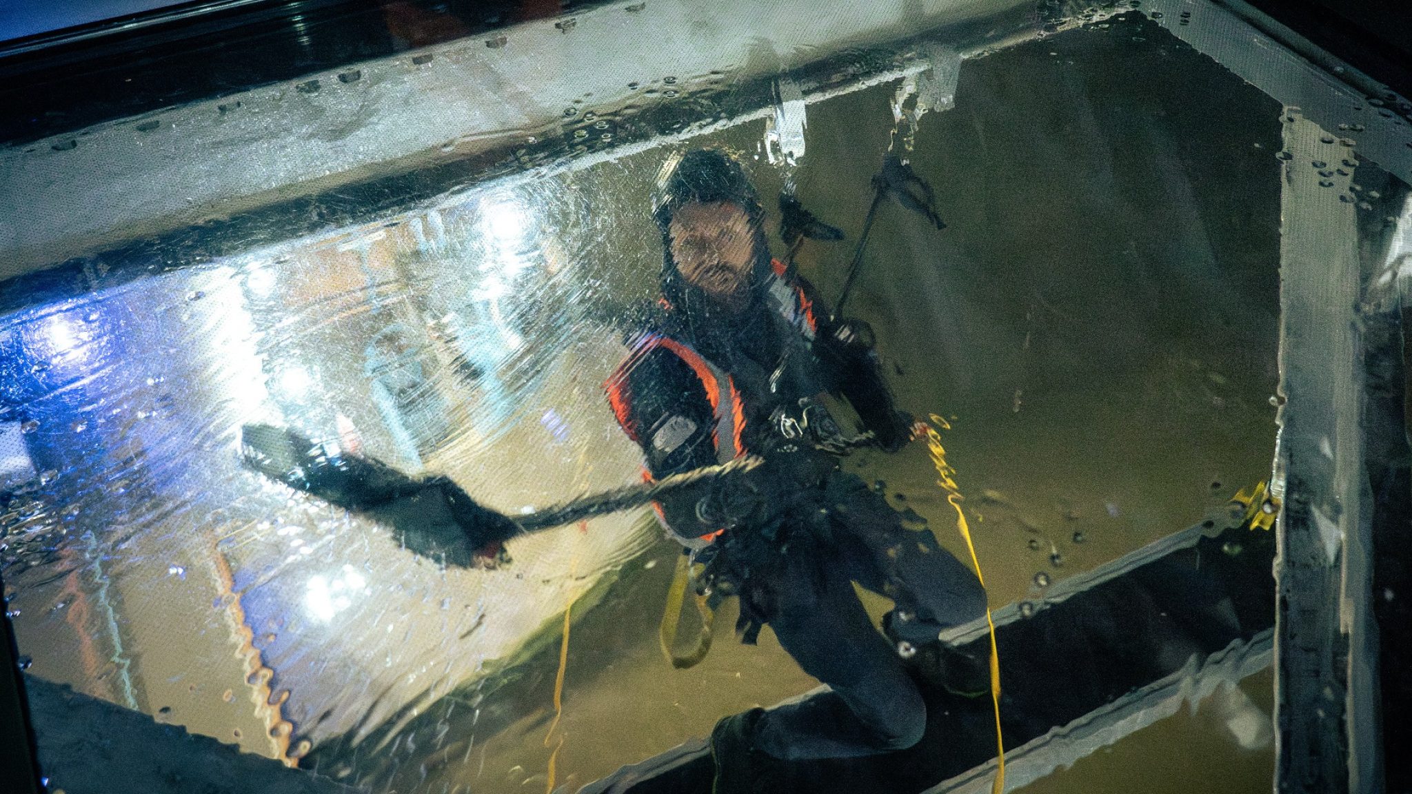An abseiling worker cleans the underside of the glass floors at Tower Bridge